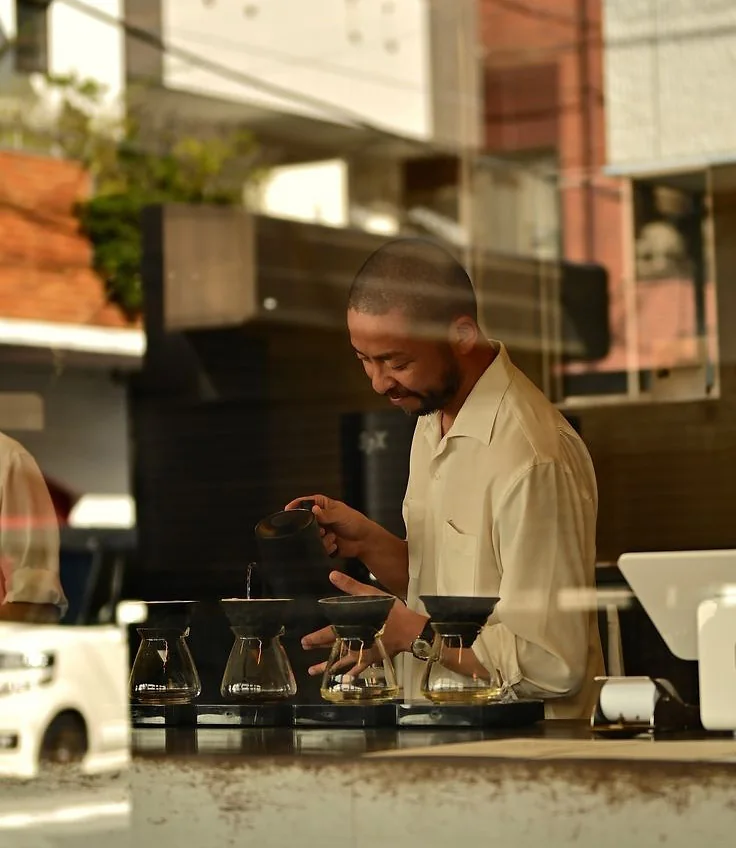 A neighbourhood café on Antique Row, pour-overs lined up on the counter.